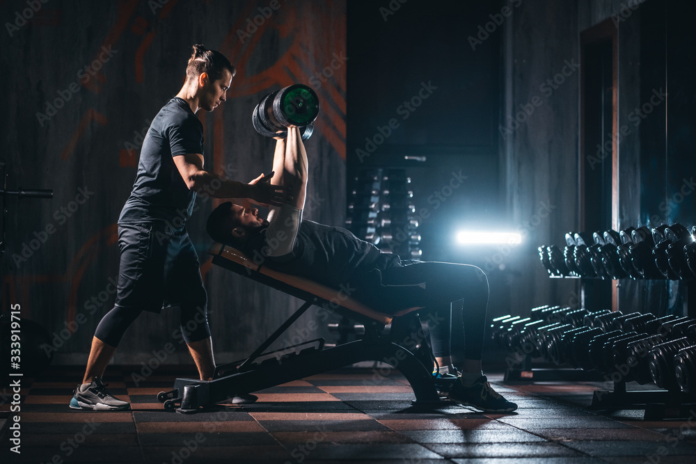 young man has workout with personal trainer in modern gym Stock Photo ...