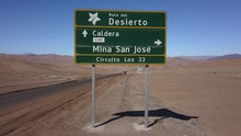 Pull Back To Reveal Mina San Jose Road Sign In Chile, Where Thirty Three Miners Were Miraculously Saved After Being Stuck Underground For Months.