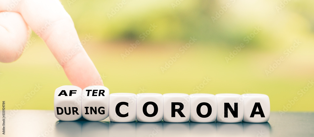 Hand turns dice and changes the expression "during Corona" to "after Corona". - obrazy, fototapety, plakaty 