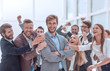 © ASDF - close up. cheerful company employees applauding their colleague.
