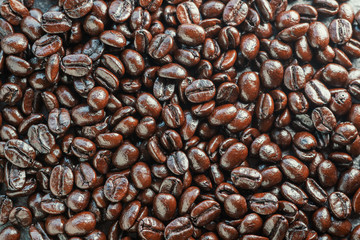 close up of dark roast arabica coffee beans background