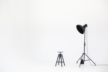 Wooden Chair With Lighting Equipment Isolated On A White Background. Space For Text. Vacant Chair. The Concept Of Selection And Casting. Job Recruitment Advertisement.