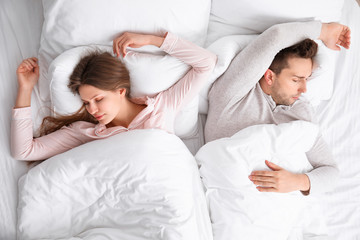 Poster - Young couple sleeping in bed