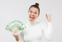 Excited Happy Young Woman Holding Lots Of Money, Fan Of Hundred Euro Banknotes In Cash, Shouting Ot Loud. Lottery Winner Concept.