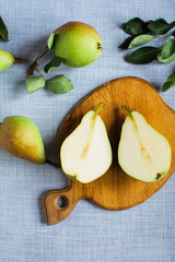 Wall Mural - pears in a plate and slices of pears top view. wooden background with pears