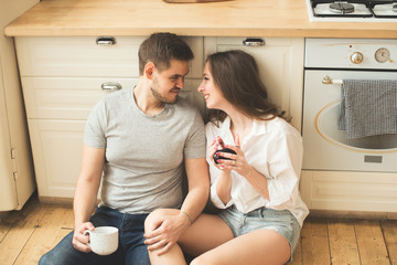 Lifestyle consept at home with couple young men and woman in kitchen