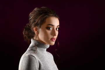 Poster - Young woman with beautiful hairdo on dark background