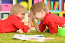 Two Smiling Boys In Red Shirts Having Fun