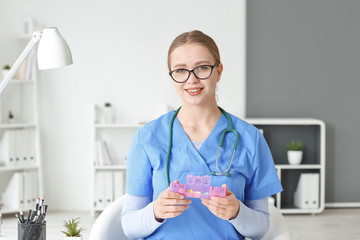 Poster - Female doctor with pills box in clinic