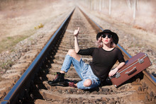 Young Traveling Woman With A Suitcase On The Railway