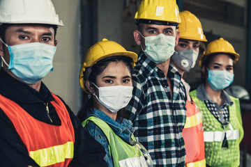 Factory workers with face mask protect from outbreak of Corona Virus Disease 2019 or COVID-19.