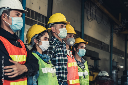 Cuadros en Lienzo Factory workers with face mask protect from outbreak of Corona Virus Disease 2019 or COVID-19