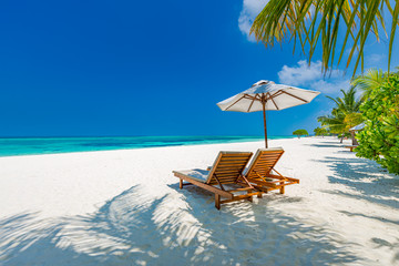 luxury beach resort, beach loungers near the sea with white sand over sea topical island background,