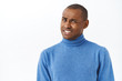 © Cookie Studio - Ouch that hurts. Portrait of embarrassed and awkward young man cringe, grimacing and looking pity camera, feel discomfort trying to say something with caution, white background