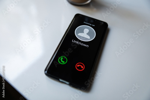 smart phone with incoming call from unknown caller. concept of scam spam and shadow calls