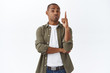 © Cookie Studio - Good point, interesting. Impressed african-american handsome male in casual clothes, raising index finger, nod in approval, agree with person during discussion, pleased stand white background