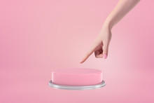 Side View Of Woman's Hand Ready To Push A Huge Pink Button On Pink Background.