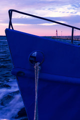 Wall Mural - Rhine fishing boat at the pier on the background of a lighthouse