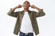 © Cookie Studio - Portrait of complaining annoyed african-american man, shouting at neihbours upstairs, complaining people listening music too loud, having noisy party, shut ears from discomfort, cant work home