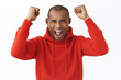 © Cookie Studio - Portrait of excited, happy rejoicing african-american man lift hands up in triumph, shouting yeah yes as watching sports game, winning bet, achieve prize, celebrating great news, white background