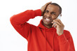 © Cookie Studio - Technology, communication and online concept. Close-up portrait of troubled african-american man talking on phone, punch forehead and grimacing displeased, forgot important task