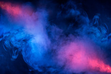 Abstract Texture Of Backlit Smoke In Red Blue On A Black Background.