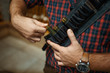 © Nomad_Soul - Man in ammo belt, rifles on background, gun shop