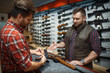 © Nomad_Soul - Man with owner choosing handgun in gun shop