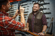 © Nomad_Soul - Man with owner choosing handgun in gun shop