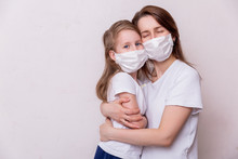 Concept Of Coronavirus Quarantine. Mother And Daughter In Medical Masks Protect Themselves From Viruses And Infections. Theme Of Health And Medicine. Medical Virus Poster Design. Free Space For Text