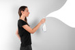 Young woman holding spray plastic bottle with cleaning liquid. Spring cleaning concept. Disinfecting