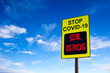 © ronniechua - Stop COVID-19 Social Distancing Sign Against Blue Sky With Copy Space