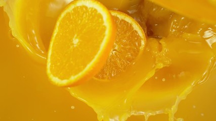 Aufkleber - Super slow motion of orange slices falling into juice. Filmed on high speed cinema camera, 1000 fps.