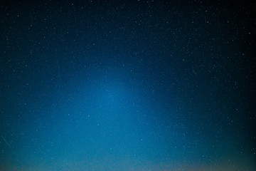 ight landscape with colorful milky way and yellow light at mountains. starry sky with hills at summe