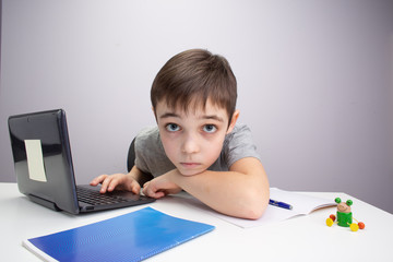 schoolboy studying homework math during his online lesson at home, social distance during quarantine, self-isolation, online education concept