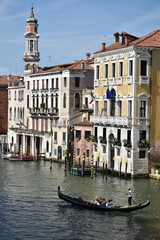 Venice canal with buildings on background and only one gondola on the water 