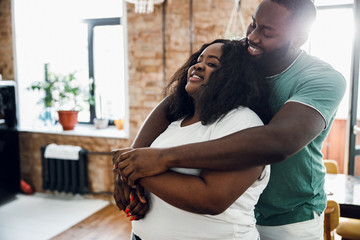 Loving man hugging his girlfriend stock photo