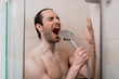 © Teodor Lazarev - Handsome young single male washing his body and face in bathroom.