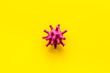 Abstract Corona virus Covid-19 strain model on yellow background top-down copy space