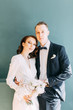 © pavelvozmischev - The bride and groom's romantic photo shoot. The newlyweds are happy together. Stylish modern couple in an interior Studio.