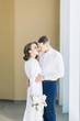 © pavelvozmischev - The bride and groom's romantic photo shoot. The newlyweds are happy together. Stylish modern couple in a light interior.