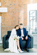 © pavelvozmischev - The bride and groom's romantic photo shoot. The newlyweds are happy together. Stylish modern couple in a light interior.