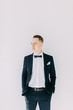© pavelvozmischev - Portraits of a man in a jacket on a neutral background. Stylish portraits of the happy groom.