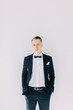 © pavelvozmischev - Portraits of a man in a jacket on a neutral background. Stylish portraits of the happy groom.