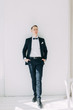 © pavelvozmischev - Portraits of a man in a jacket on a neutral background. Stylish portraits of the happy groom.
