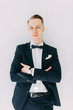 © pavelvozmischev - Portraits of a man in a jacket on a neutral background. Stylish portraits of the happy groom.