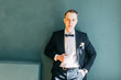 © pavelvozmischev - Portraits of a man in a jacket on a neutral background. Stylish portraits of the happy groom.