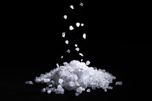 Sea Salt Crystals Fall On A Pile Of Salt, Black Background