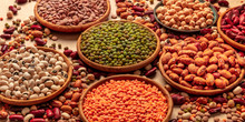 Legumes Assortment On A Brown Background. Lentils, Soybeans, Chickpeas, Red Kidney Beans, A Vatiety Of Pulses