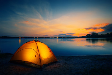 Wall Mural - orange tent on the lake at dusk
